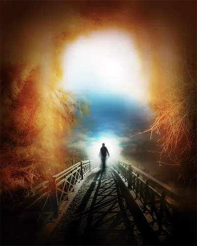 Man walking on bridge walking towards light