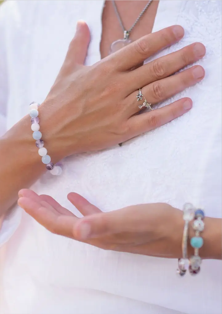 Lady in white shirt with hand on heart