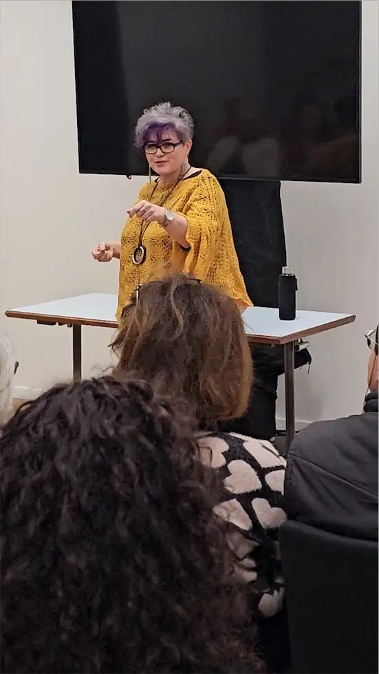 Tatjana demonstrating at mednat in yellow poncho