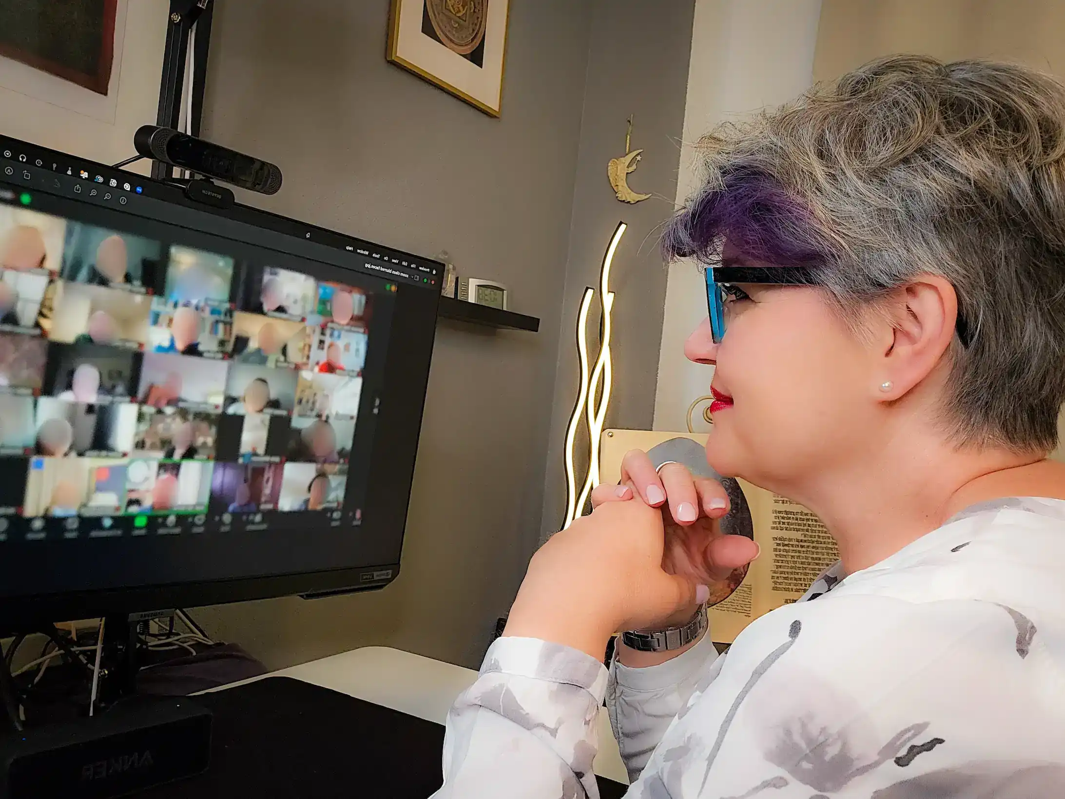 Tatjana teaching on Zoom with hands folded